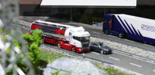 Model trucks illustrate fleet communications and IoT technologies in an