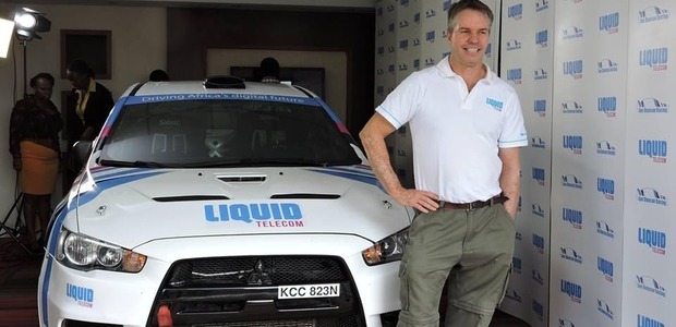 Ian Duncan poses next to his Liquid Telecom-branded rally car