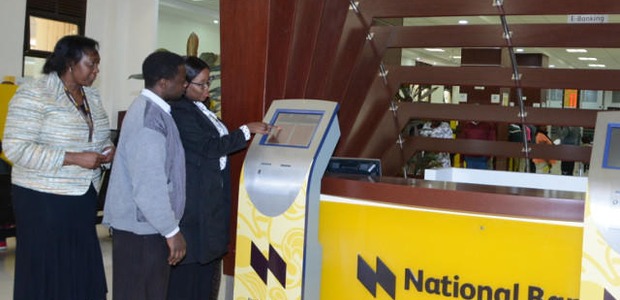 NBK employees assist customers use new queue equipment