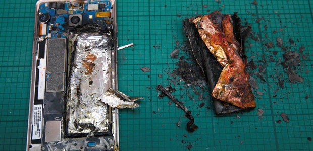 A Samsung Note7 is pictured next to its charred battery