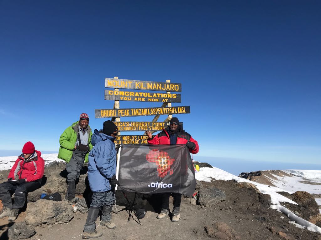 .africa flag flies proud atop Kilimanjaro