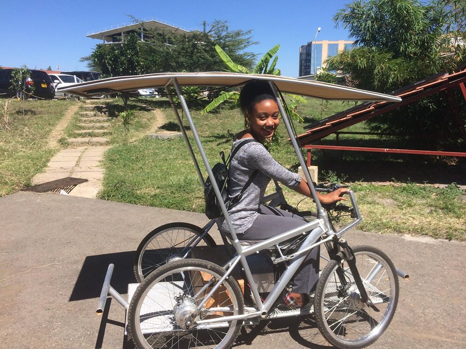 A lady tries the Solar E-Cycle bike