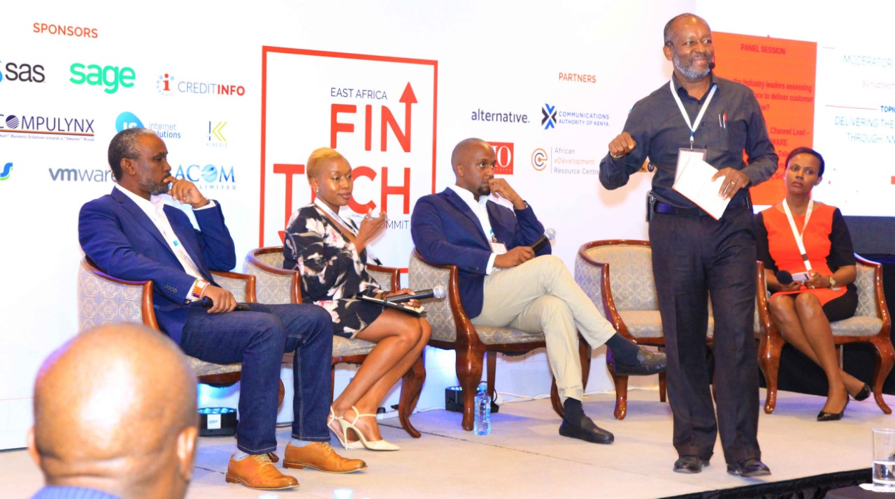 Robert Yawe(standing), moderates a panel at the fintech summit (photo