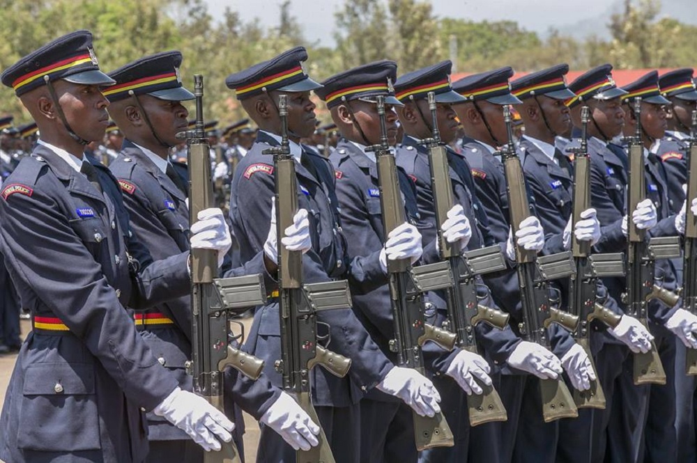Kenya's National Police Service personnel present arms during a guard