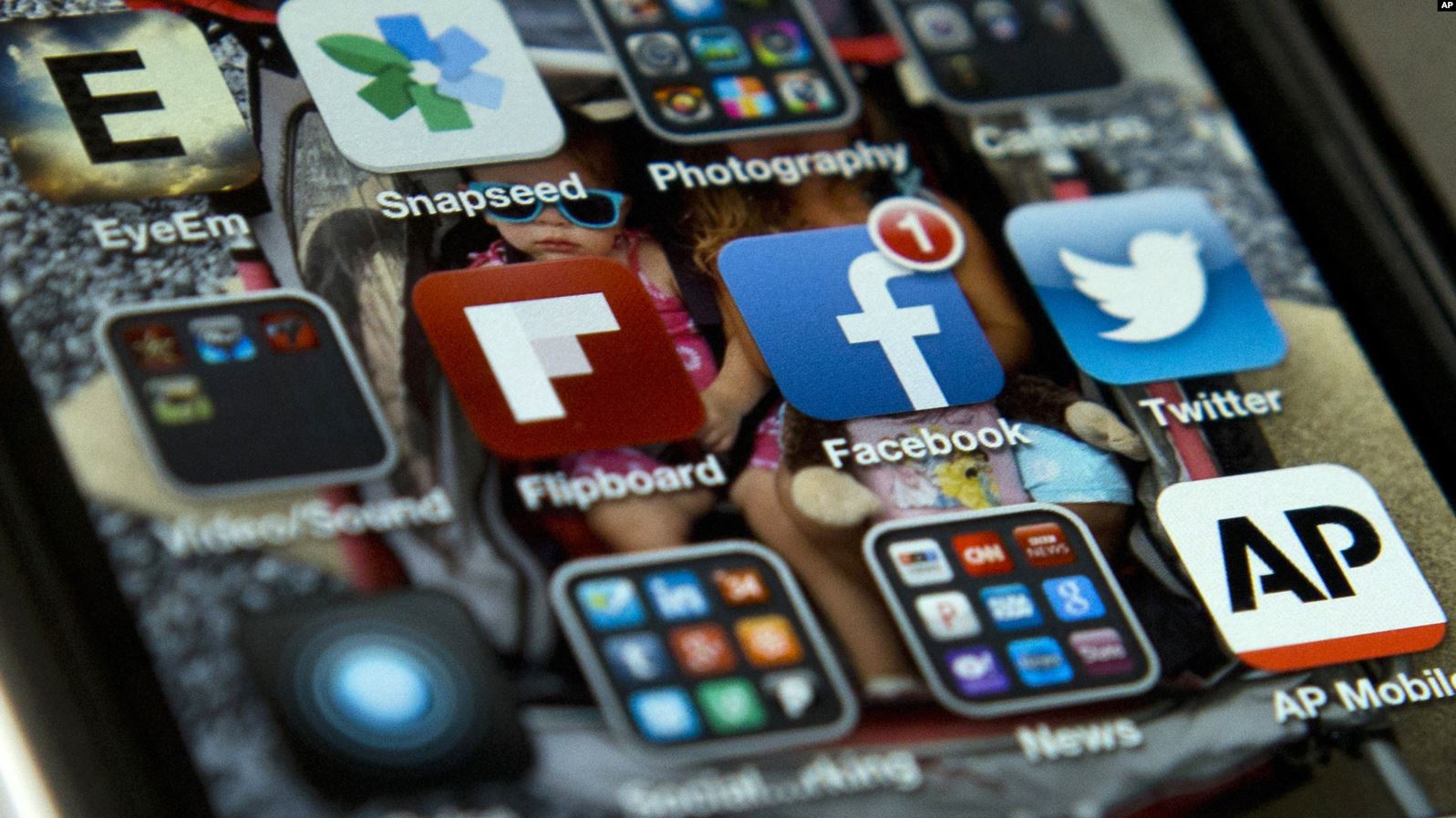A phone screen displays social media apps