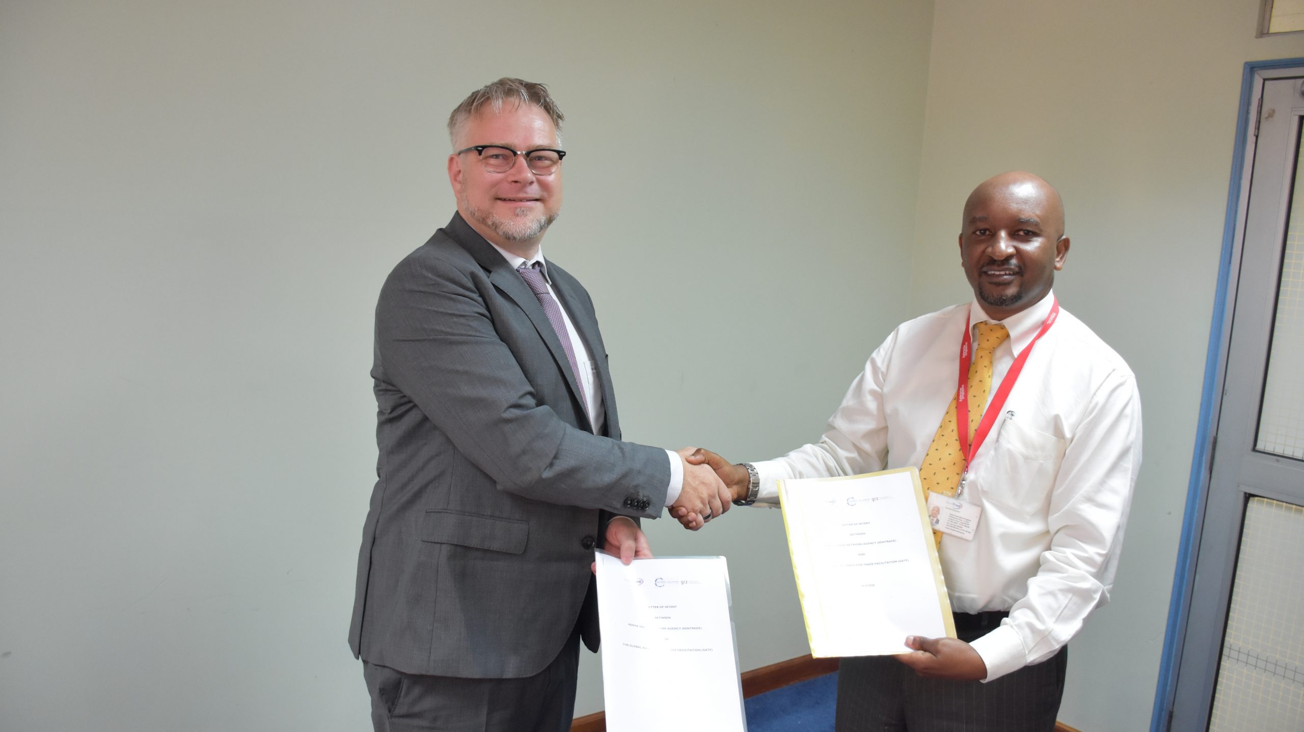 Amos Wangora, CEO KenTrade exchanges the partnership documents with a