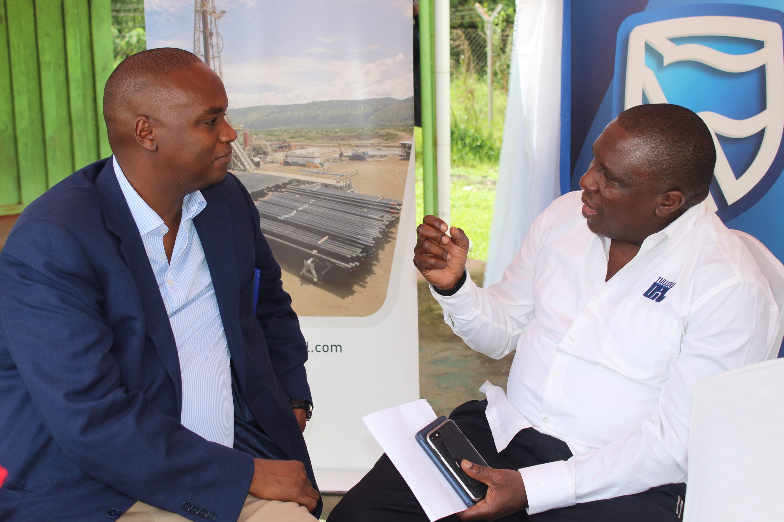 Stanbic Chief Executive Patrick Mweheire interacts with Tullow Uganda Managing