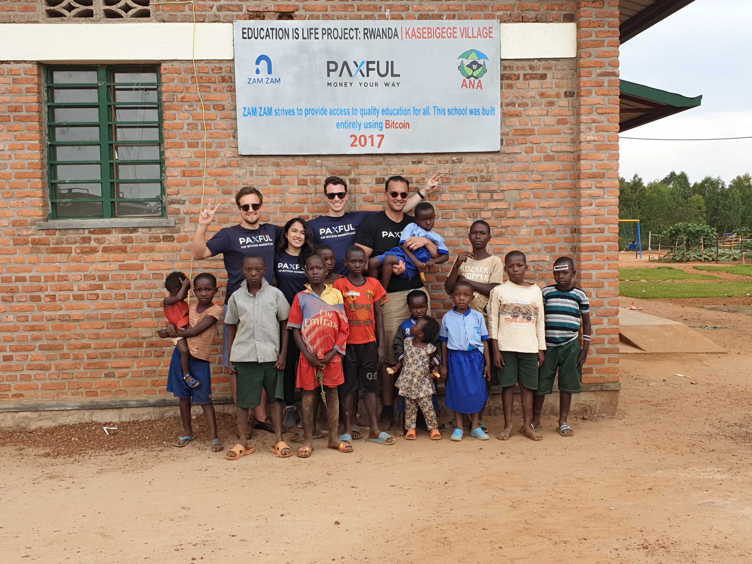 Ray Youssef, CEO and co-founder of Paxful pose with beneficiaries