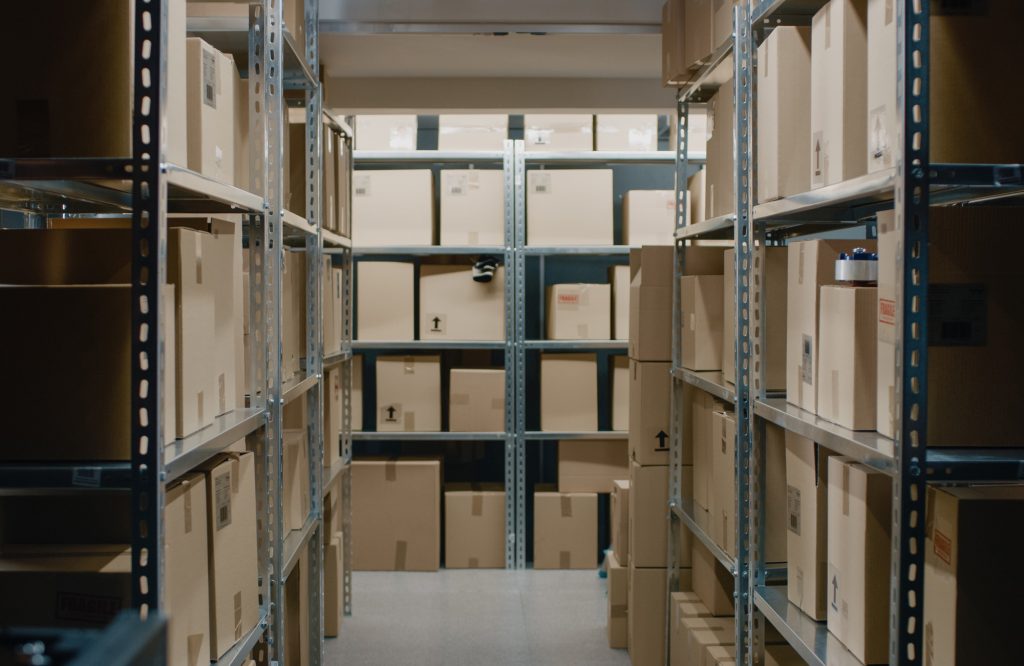 Shot Inside Warehouse Storeroom with Rows of Shelves Full Cardboard
