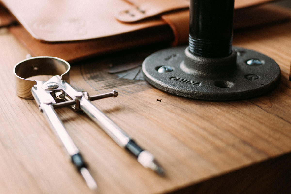 architecture_architectural-tools_wood-grain_compass_photo-by-jeff-sheldon-on-unsplash-100809521-large