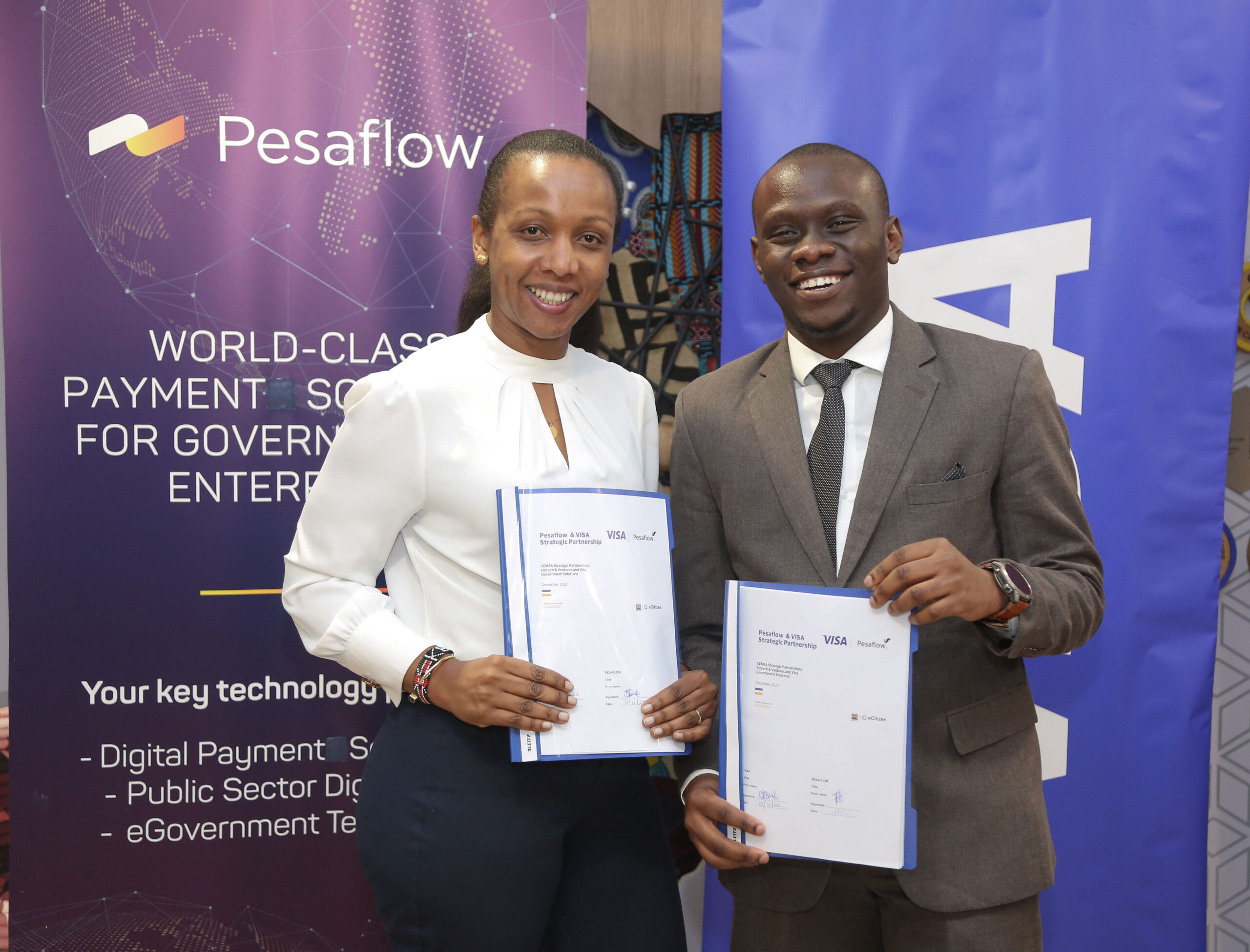 Visa Kenya Country Manager, Eva Ngigi-Sarwari and Pesaflow CEO, Evid Sibi during the strategic partnership signing ceremony between Visa and Pesaflow.