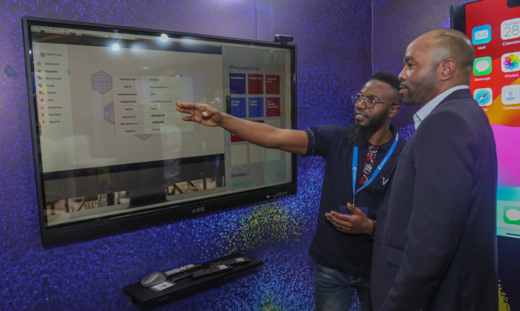 Visa East Africa Cluster Country Manager and Vice President Chad Pollock is taken through the online mall platform by George Ngotho head of IT at the Visa Studio during the Visa Tech Summit at Sarit Centre, Nairobi.