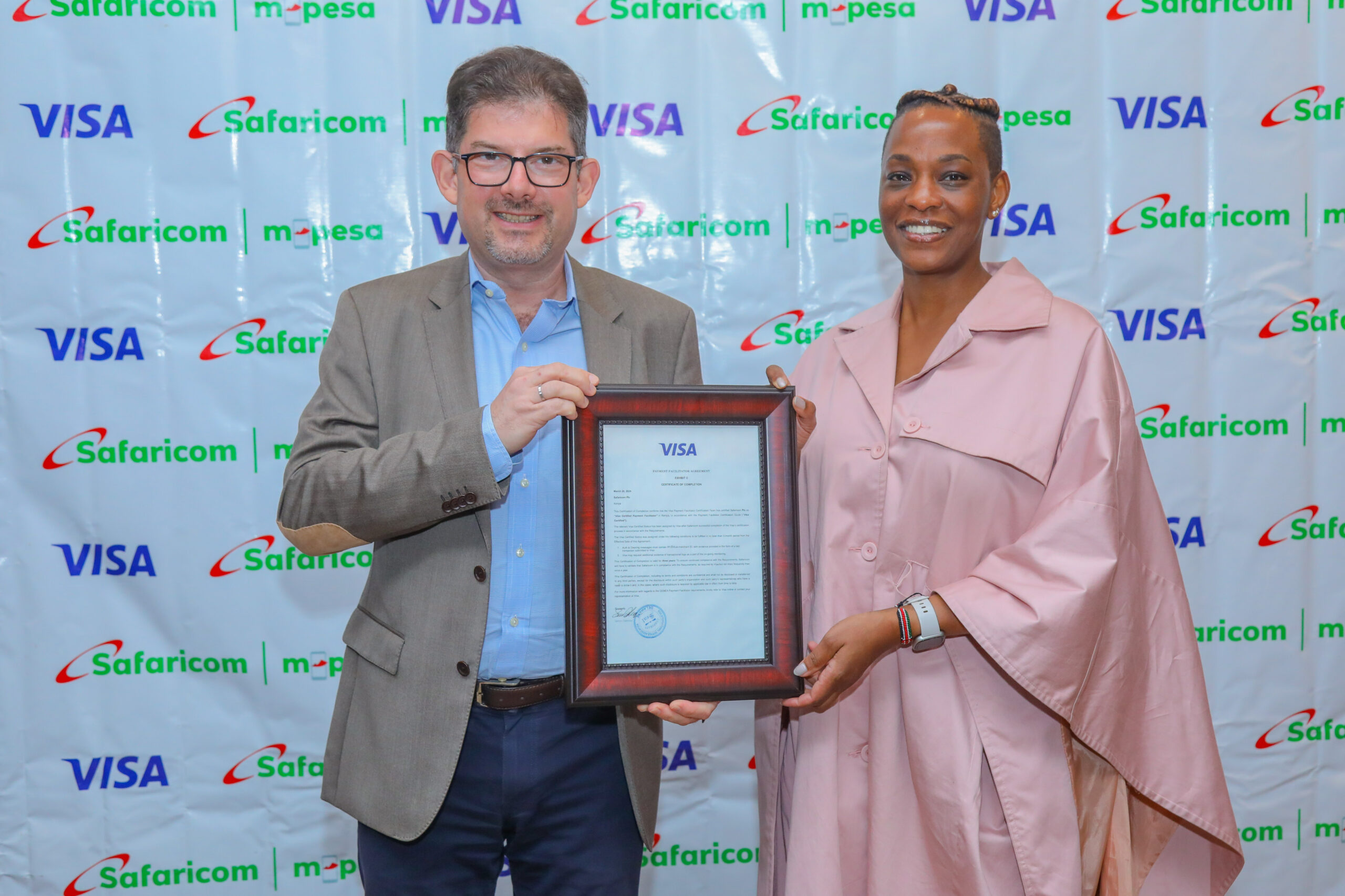 Visa’s SVP CEMEA Merchant Sales and Acquiring -Michael Berner hands over a certificate of completion to Safaricom’s , Chief Financial Services Officer- Esther Waititu during a Dinner held at Capital club to celebrate the partnership between Visa and Safaricom. The cirtificate certifies Safaricom PLC as a VISA CERTIFIED PAYMENT FACILITATOR IN KENYA.