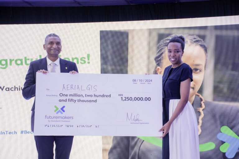 Dr Vincent Ogutu, Vice Chancellor of Strathmore University, presents an award to Nancy Wachiuri, Founder of Aerial GIS, one of the winners of Women in Tech. Cohort 7